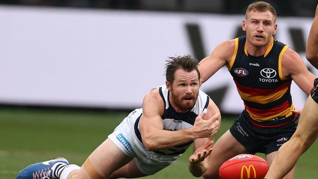 Patrick Dangerfield of the Cats clears by hand in front of Rory Laird. Picture: Michael Klein