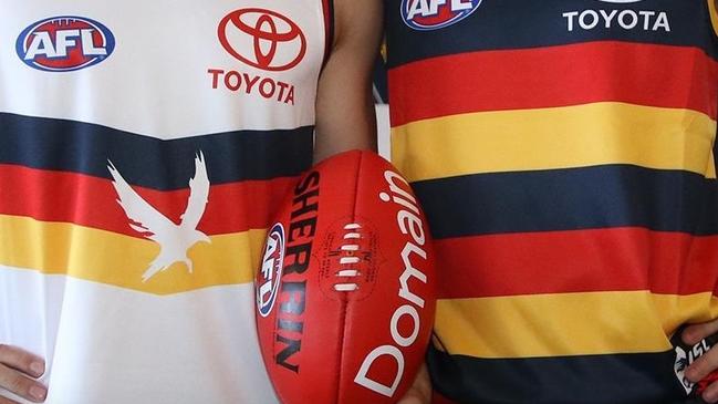 Lachlan Murphy and Ned McHenry show off the Crows' new guernseys for the 2020 AFL season.