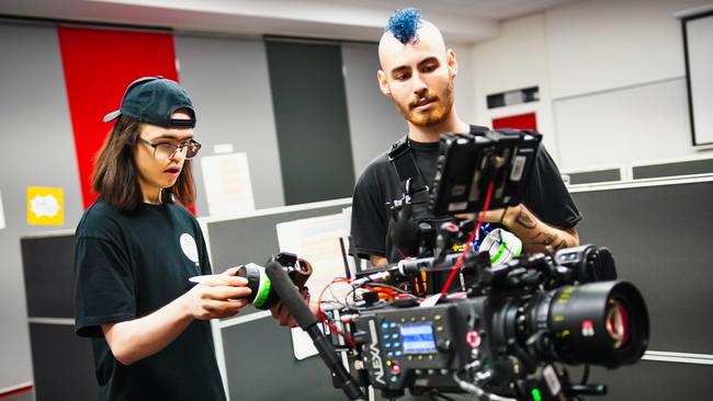 Bus Stop Films participant Luke with the 1st AC (First Assistant Camera) on the set of Middle Management. Picture: Supplied