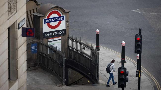 A solitary pedestrian leaves Bank tube station in the City of London.