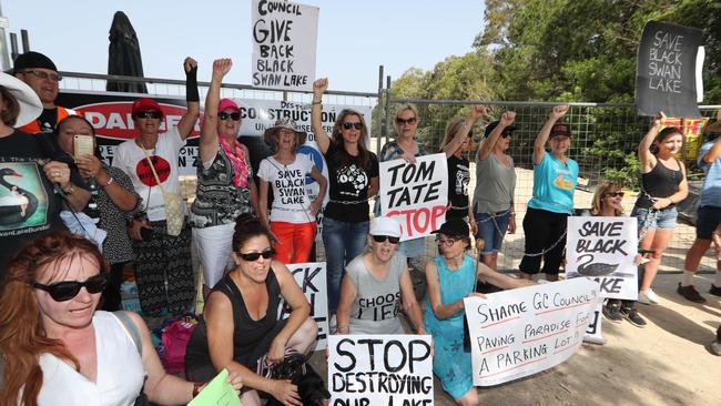 Black Swan Lake protest at Bundall goes to another level, with protesters chaining themselves to the fence and then getting themselves arrested after running onto the worksite and stopping the trucks … Picture Glenn Hampson
