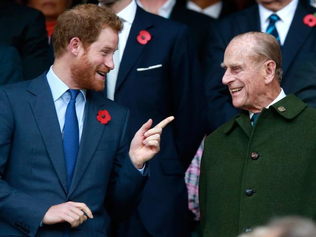 Prince Harry and Prince Phillip enjoy the atmosphere during the 2015 Rugby World Cup Final match between New Zealand and Australia at Twickenham Stadium. Picture: Getty