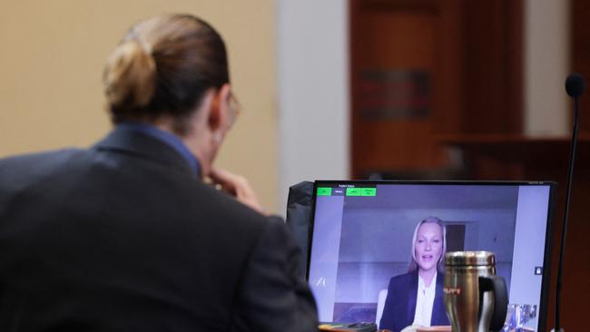 Johnny Depp listens as Kate Moss testifies. (Photo by EVELYN HOCKSTEIN / POOL / AFP)