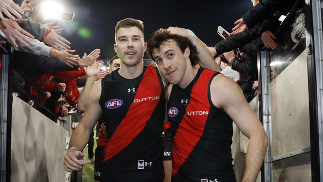 NCA . MELBOURNE, AUSTRALIAÃ July 5 , 2024.  AFL  Round 17. Collingwood vs Essendon at the MCG.   Zach Merrett , captain of the Bombers  and Andrew McGrath , who played his 150th game led the team off the MCG    . Pic: Michael Klein