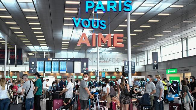 Travellers, line up at the Orly Airport, south of Paris on Saturday. Picture: AFP