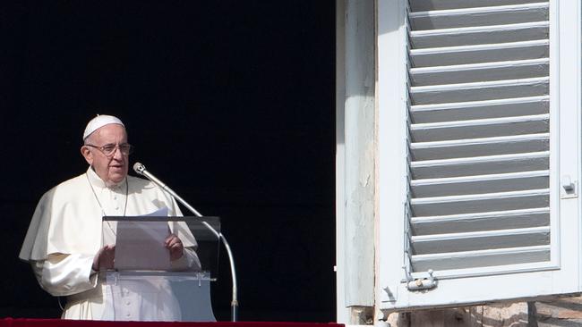 Pope Francis addresses the crowd from the window of the apostolic palace overlooking Saint Peter's square during his Sunday Angelus prayer on December 2, 2018. (Photo by Tiziana FABI / AFP)