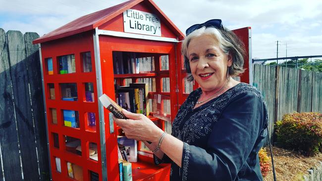 Robbie Kennedy says she borrows a book from the Little Free Library 