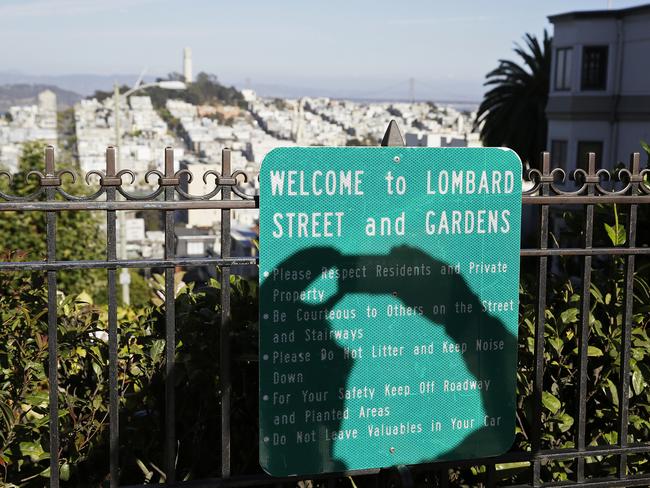 A sign near the street asks visitors to respect residents. Picture: AP/Eric Risberg