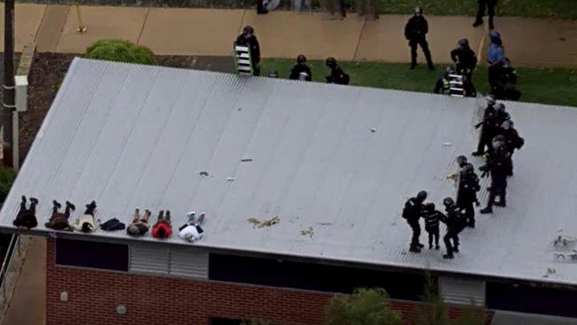 Special operations group officers in riot gear storm the roof the Banksia Hill Juvenile Detention Centre in Perth’s southeast as detainees begin to surrender. Picture: ABC