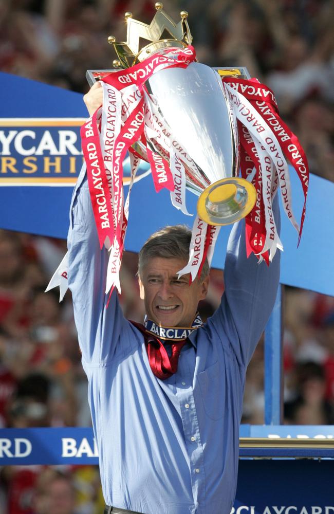 Arsenal's manager Arsene Wenger holds up the Premiership trophy after winning the Premiership title and defeating Leicester City at Highbury in London.