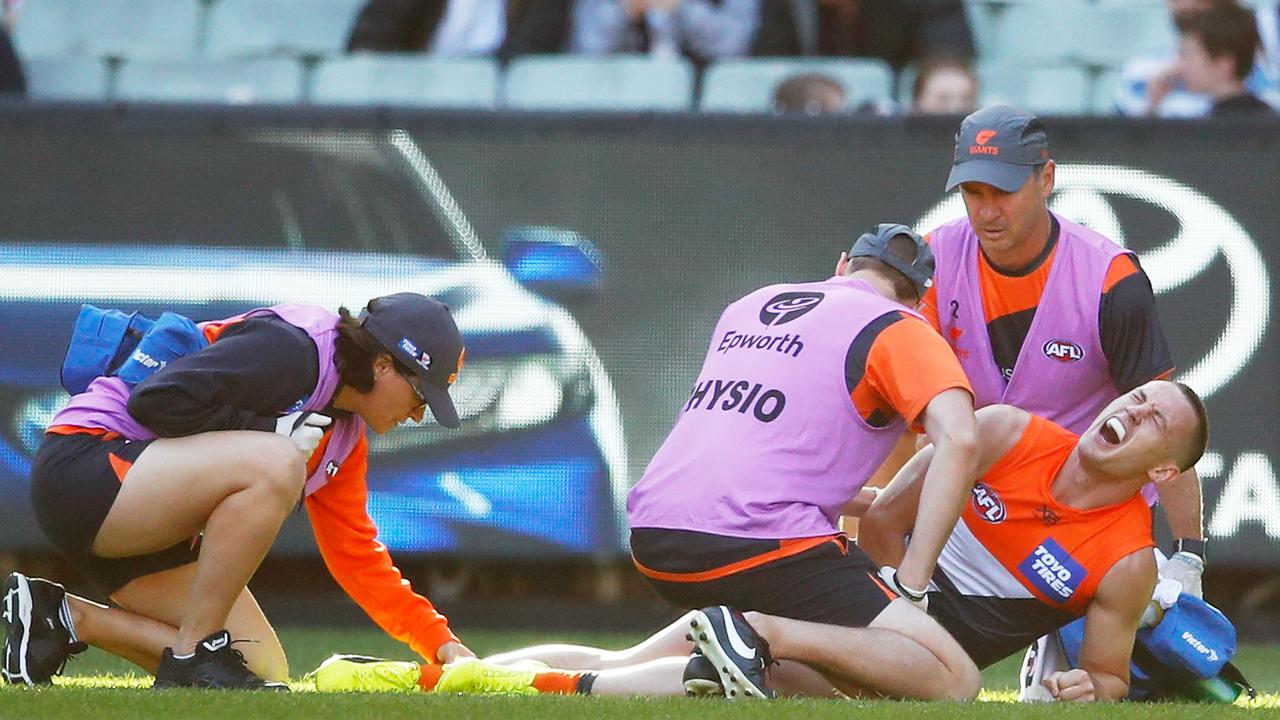 Tom Scully lies on the MCG after breaking his ankle in Round 2.