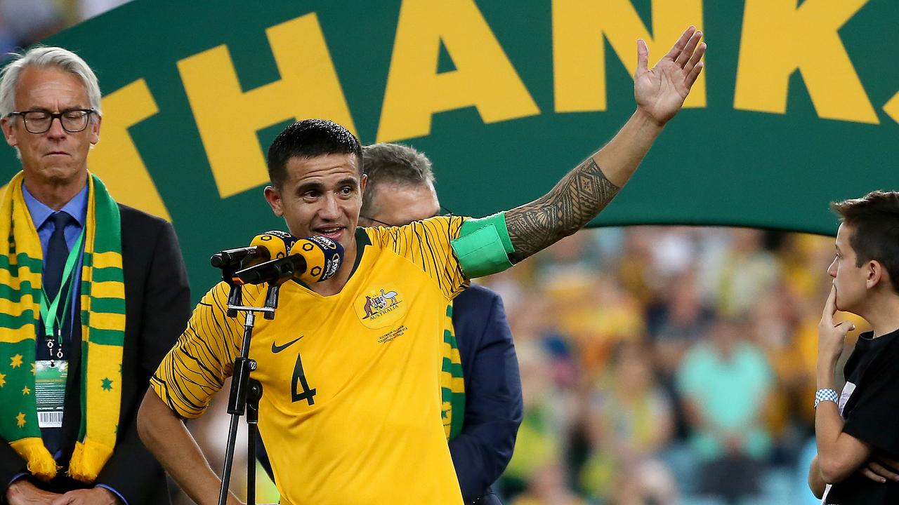 Tim Cahill is presented with a commemorative ball after his final game for the Socceroos