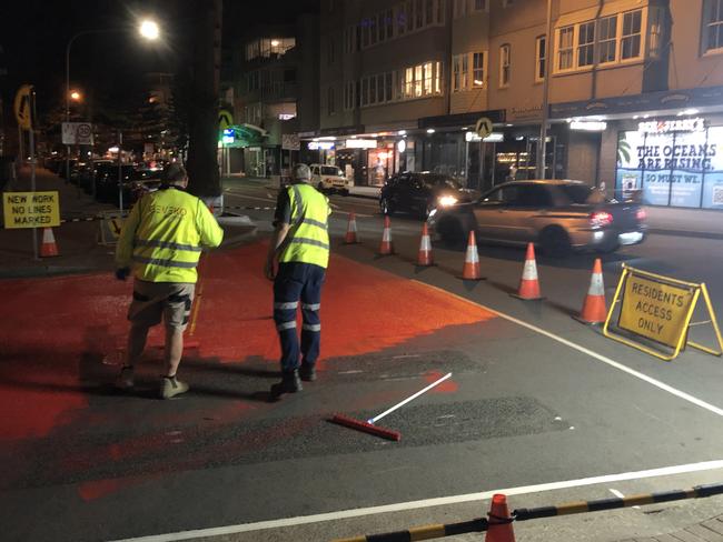 Contractors painting the road surface at the intersection of Wentworth St and South Steyne on Sunday night. Another 3D crossing will be installed at the intersection of South Steyne and Victoria Pde. Picture: Jim O'Rourke