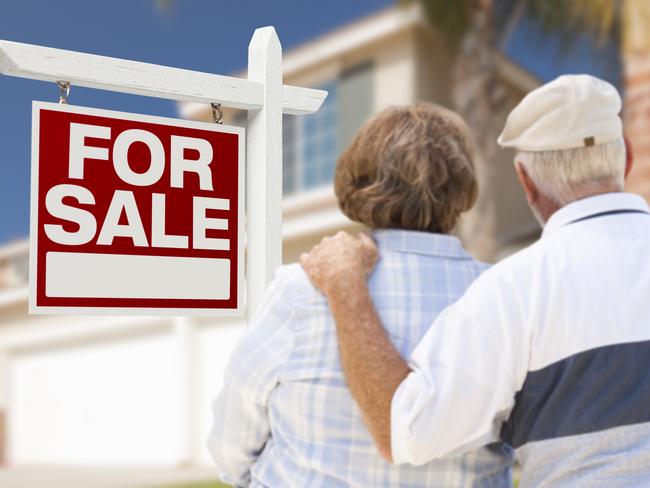 Happy Senior Couple Front of For Sale Sign and House. Picture: THINKSTOCK