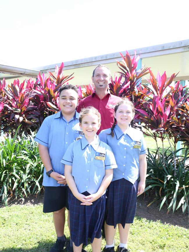 Cairns Adventist College students Evander Paletua, McKenna Coe and Milly Suchanek with principal Adam Coe look forward to the construction of the school’s year 7 building, as it transitions into a prep to year 12 education facility. Picture: Catherine Duffy