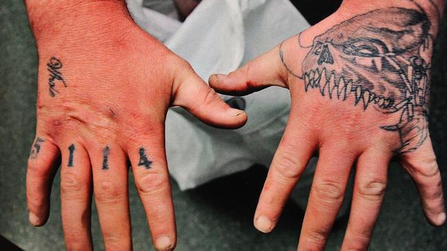 The hands of Raymond Jones, a former member of the Comancheros who was jailed for stabbing a man without provocation.