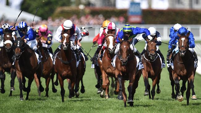 Nick Hall (blue and green silks) sets Jameka alight as they close on victory in the Caulfield Cup. Picture: AAP