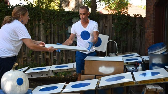 Jason Brown and his wife, Ruth Brown, handcraft political signs featuring a simple blue dot, at their home in Omaha, Nebraska. Picture: AFP