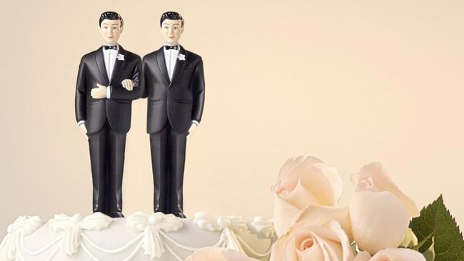 Homosexual wedding cake topper showing two grooms, men and rose flowers. THINKSTOCK