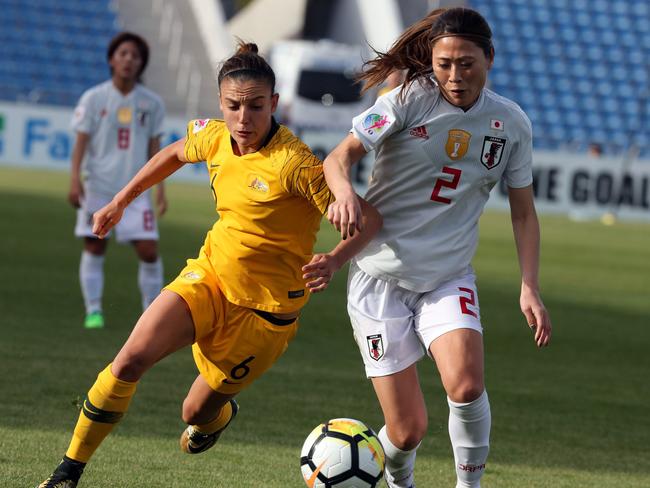 Australia's midfielder Chloe Logarzo (L) controls the ball ahead of Japan's defender Utsugi Rumi.