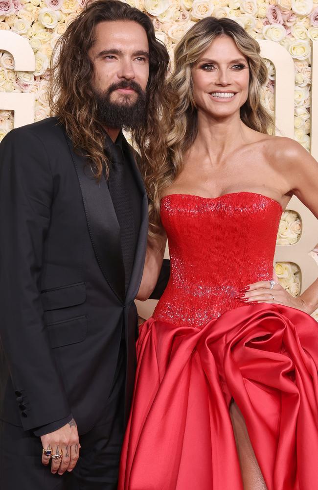 Tom Kaulitz, 35, and Heidi Klum, 51, posing for pictures together at the 81st Annual Golden Globe Awards in January 2024. Photo: Amy Sussman/Getty Images.