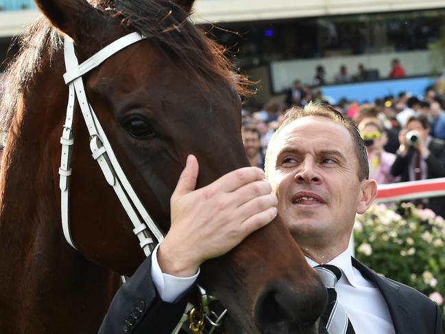 Trainer Chris Waller embraces Winx after a Cox Plate win. Picture: AAP