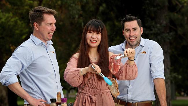 Cattle-farming brothers James and Rhys Williamson with student Iris Wang. Picture: Colin Murty