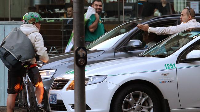 A cyclist and taxi driver exchange heated words in Sydney.