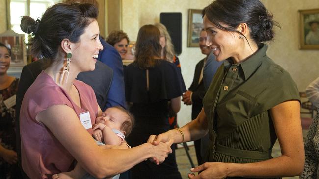 Meghan Markle speaks to Missy Higgins. Picture: AP Photo/Steve Christo