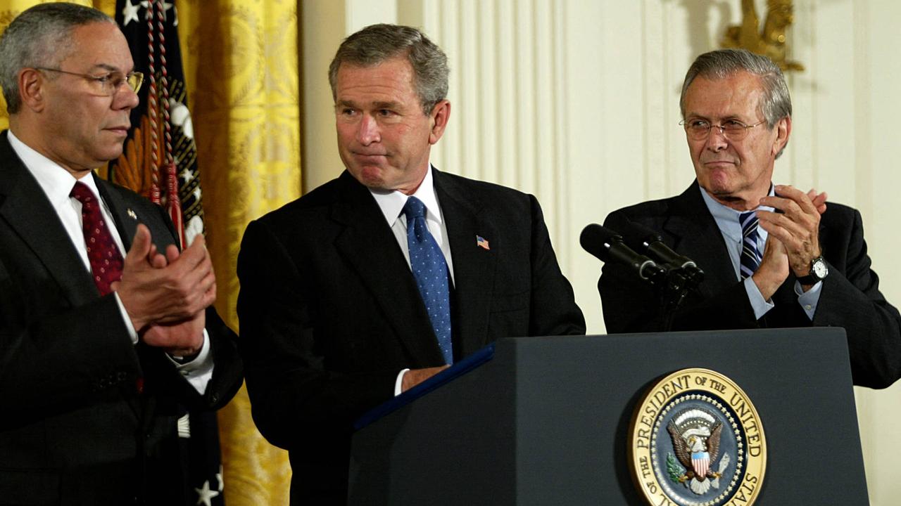 Former US President George W .Bush (C) with former Secretary of State Colin Powell (L) and former Secretary of Defence Donald Rumsfeld (R.