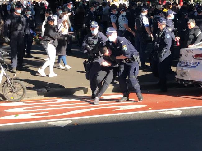Another man who had to be bundled away from the crowd.