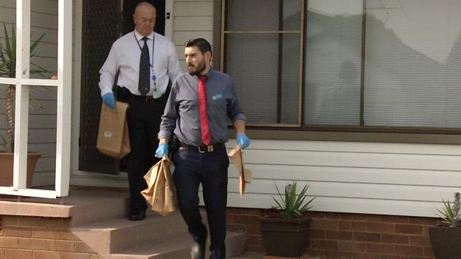 Detectives seize items from the home of Emma Elizabeth Arnold, who was arrested in St Marys this morning. Picture: NSW Police