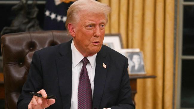 Donald Trump signs an executive order  in the Oval Office of the White House. Picture: AFP.