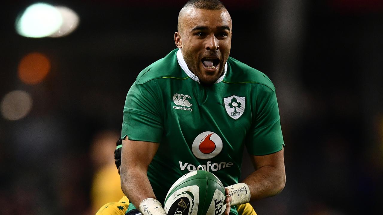 Simon Zebo of Ireland is tackled by Henry Speight of Australia.