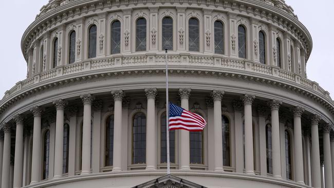 An American Flag flies at half staff at the US Capitol to honour two Capitol Police officers who died following the violence on Capitol Hill. Picture: AFP.