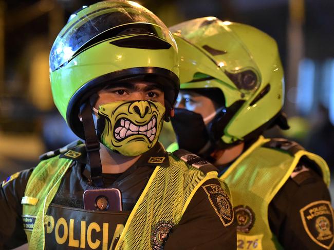 Police officers use face masks as a preventive measure against the spread of the new coronavirus, COVID-19, in Cali, Colombia.