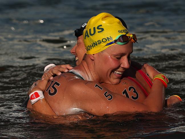 PARIS, FRANCE - AUGUST 08: Moesha Johnson of Team Australia and Ginevra Taddeucci of Team Italy celebrate after winning silver and bronze in the Marathon Swimming Women's 10k on day thirteen of the Olympic Games Paris 2024 at Pont Alexandre III on August 08, 2024 in Paris, France. (Photo by Sarah Stier/Getty Images)