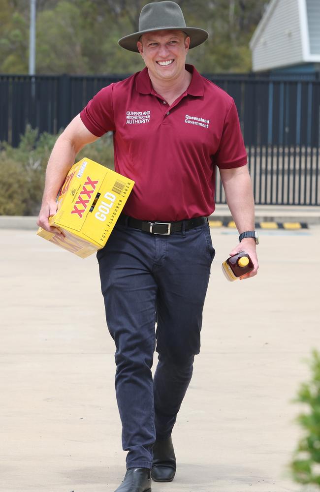 Acting Premier Steven Miles bearing XXXX and rum for Bundaberg firefighters. Picture: Annette Dew