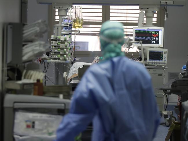 A doctor watches a coronavirus patient under treatment in the intensive care unit of the Brescia Hospital in Italy. Italian hospitals are struggling to make room for the onslaught of coronavirus patients. Picture: AP