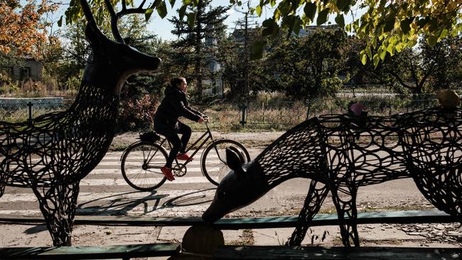 A resident rides a bicycle in the recently retaken town of Yampil, near Lyman, in Donetsk region. Picture: AFP