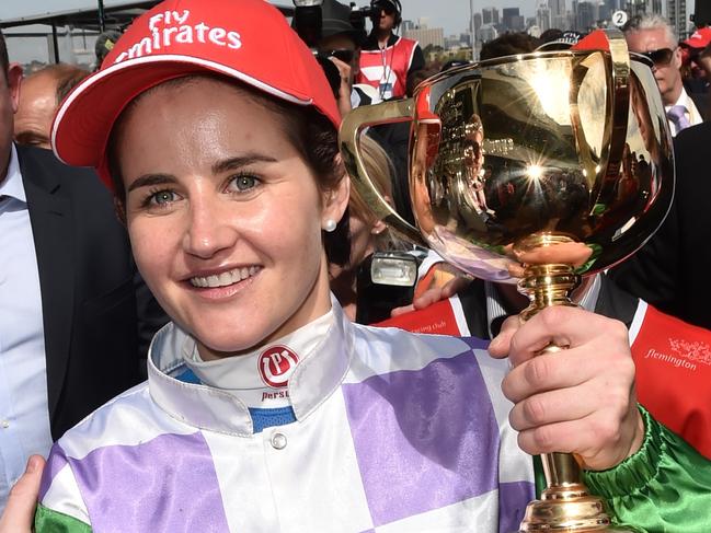 Michelle Payne celebrates after winning the Melbourne Cup on Prince of Penzance at Flemington Racecourse in Melbourne, Tuesday, Nov. 3, 2015. (AAP Image/Julian Smith) NO ARCHIVING, EDITORIAL USE ONLY