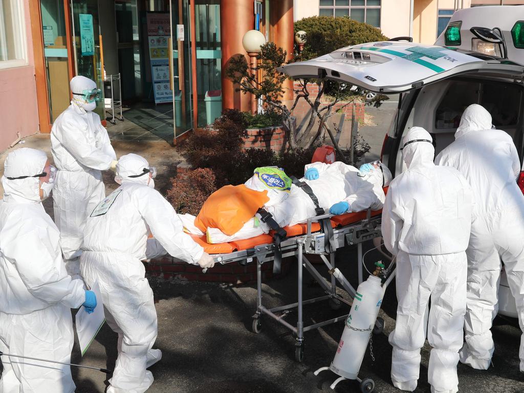 Medical workers transfer a suspected coronavirus patient to hospital in South Korea. Picture: Yonhap/AFP