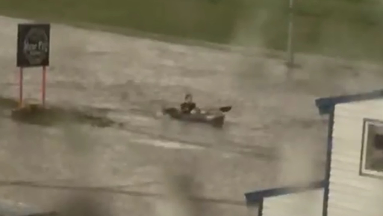 Kayaker Paddles Down Flooded Alaska Street