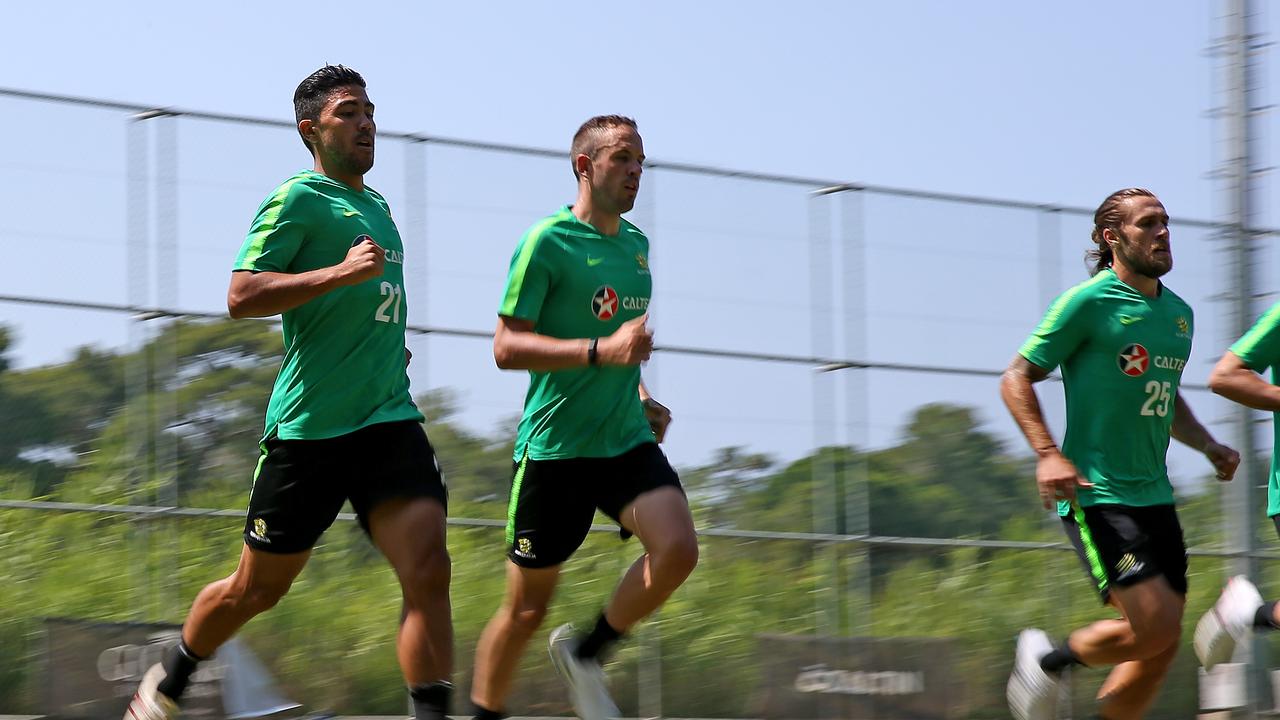 Massimo Luongo, Milos Degenek and Josh Brillante run a beep test during a Socceroos training session.