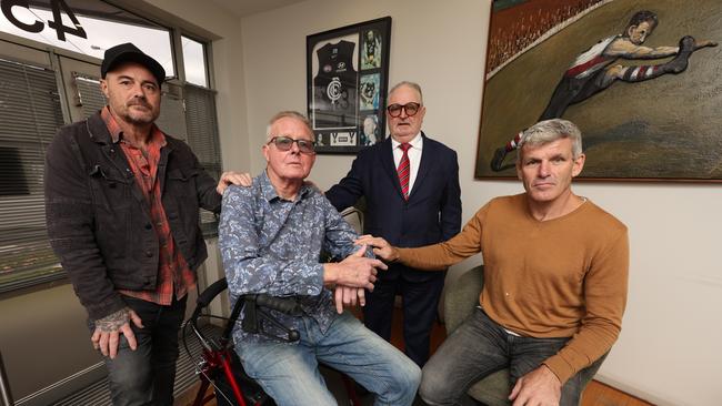 From left, former AFL players Robbins, Stoneham and Smith with player agent Jess, rear.