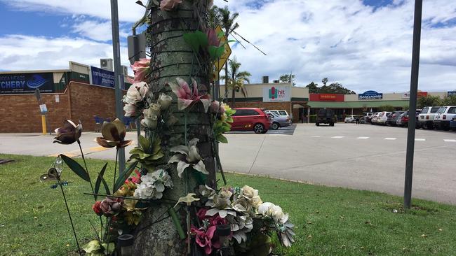 A makeshift memorial at the scene of the incident at a Nambucca shopping centre car park.