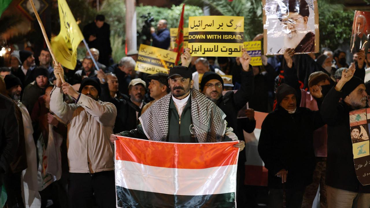 An Iranian protester holds a Yemeni flag during a demonstration in solidarity with the Palestinian people and Yemeni rebels in Tehran. Picture: AFP,