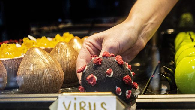 A waitress takes a dessert in shape of the coronavirus in a cafe in Prague. Picture: AFP