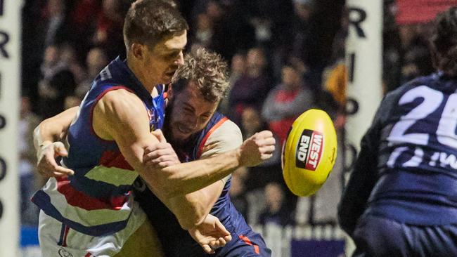 Central District’s Darcy Pisani gets the ball away under pressure from Norwood’s Mitchell Wilkins at The Parade. Picture: Matt Loxton