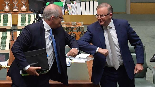 Scott Morrison and Anthony Albanese bump elbows at the conclusion of Question Time in the House of Representatives at Parliament House on December 10 this year. Picture: Getty Images